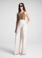 woman wearing brown cropped tank and white pants