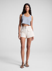 woman wearing grey cropped tank and beige shorts