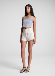 woman wearing grey cropped tank and beige shorts