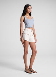 woman wearing grey cropped tank and beige shorts