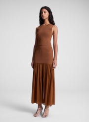 woman wearing brown top and matching skirt