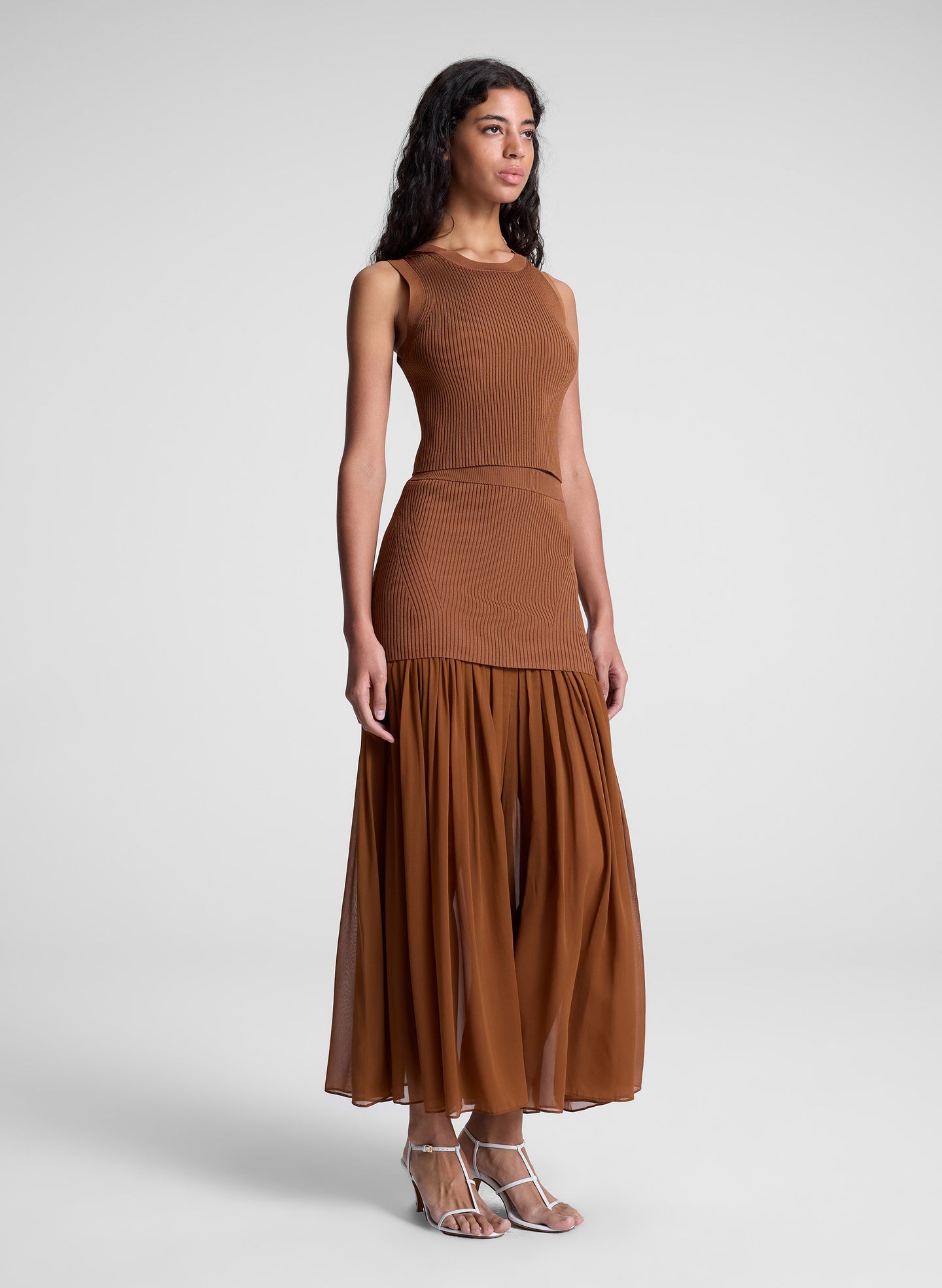 woman wearing brown top and matching skirt