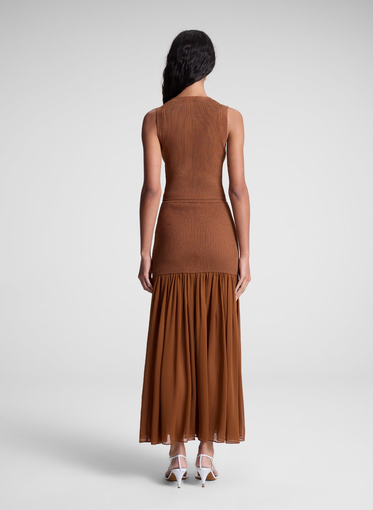 woman wearing brown top and matching skirt