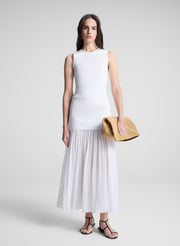 woman wearing white top and matching maxi skirt