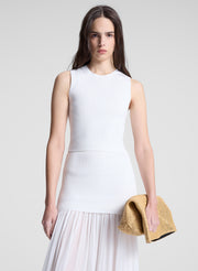 woman wearing white tank top and matching skirt