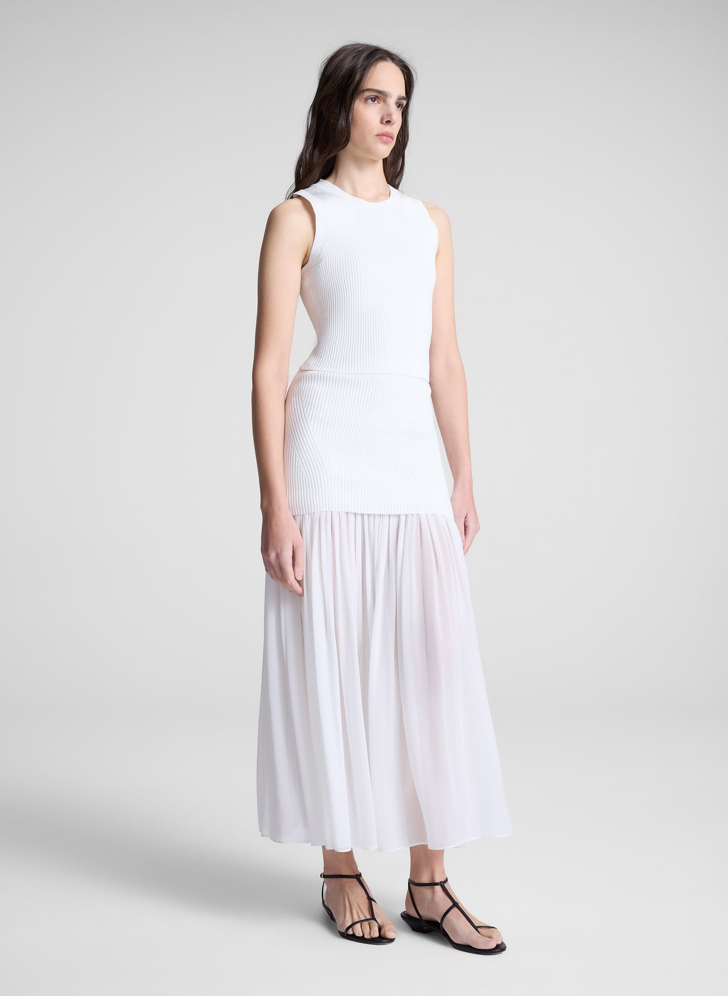 woman wearing white top and matching maxi skirt