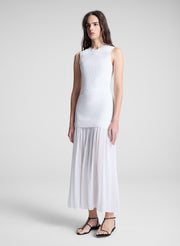 woman wearing white tank top and matching skirt