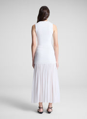 woman wearing white tank top and matching skirt