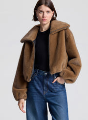 woman wearing brown faux fur jacket and jeans