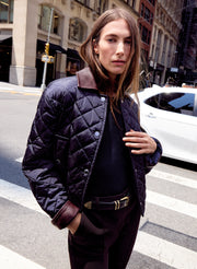 woman wearing navy blue quilted jacket