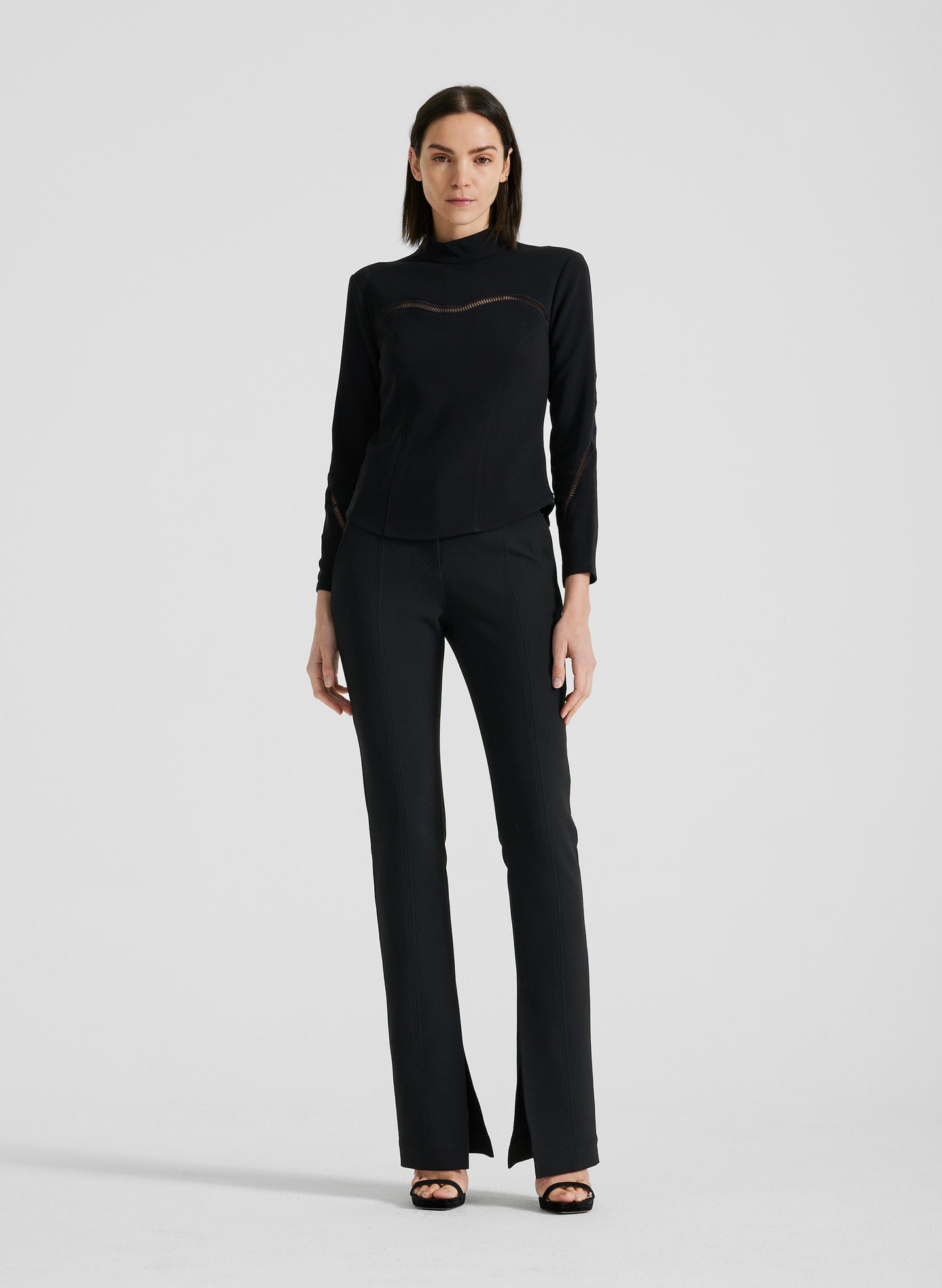 front view of woman wearing black long sleeve shirt and black pants