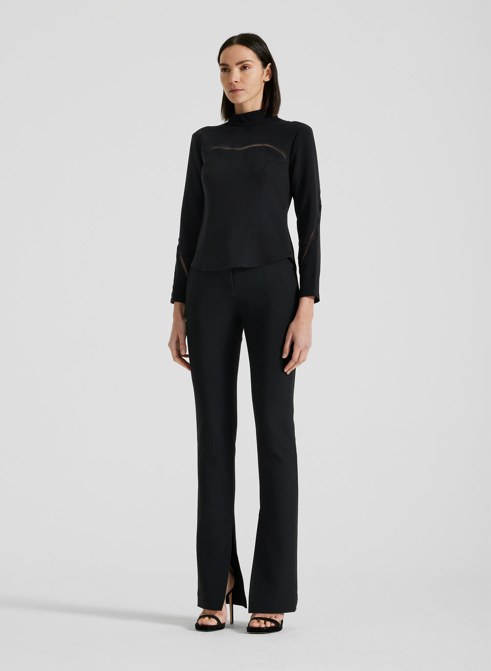 side view of woman wearing black long sleeve shirt and black pants