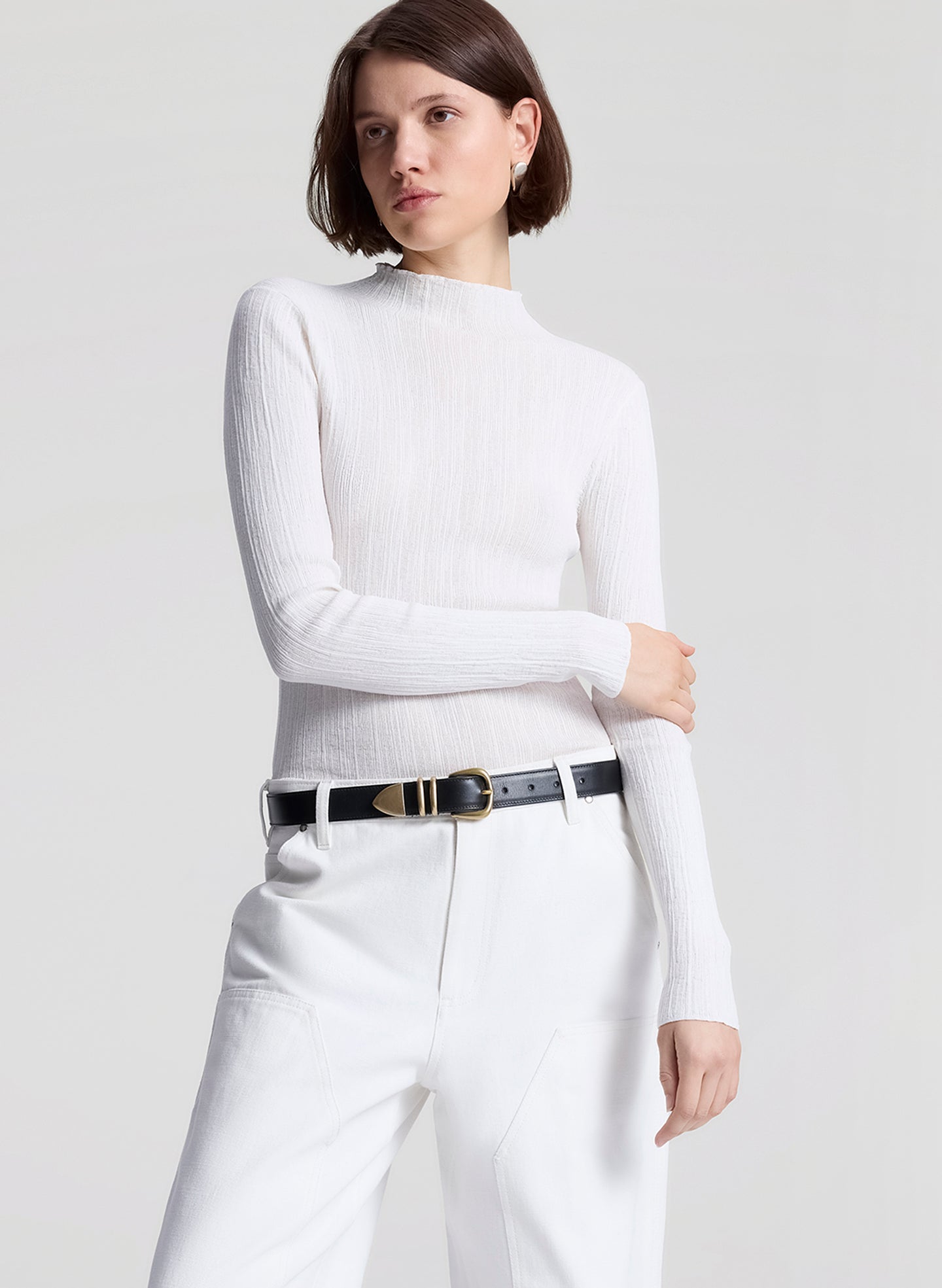 woman wearing white fine gauge voile knit top and white denim jeans