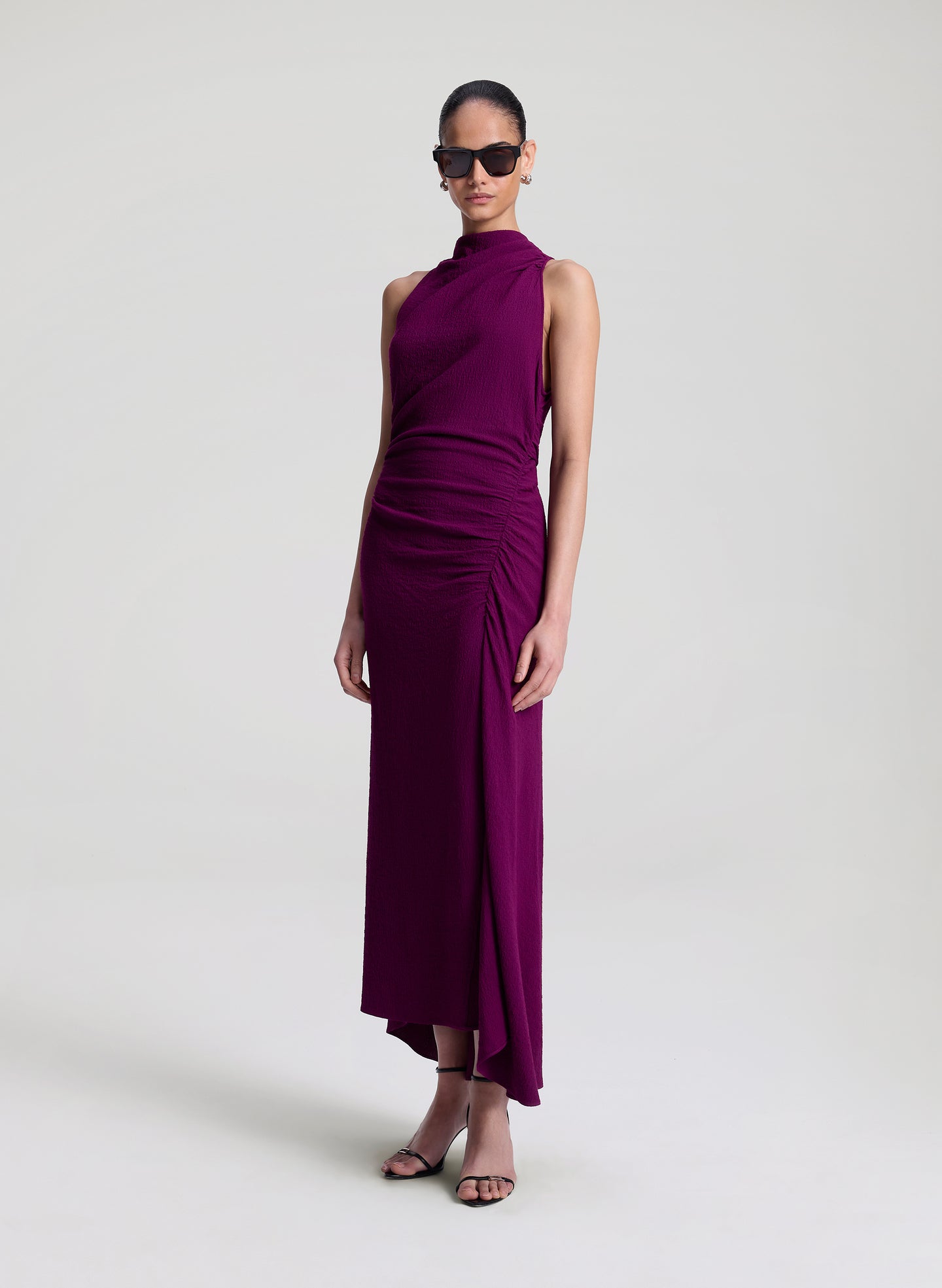 Woman wearing a purple dress on a white background