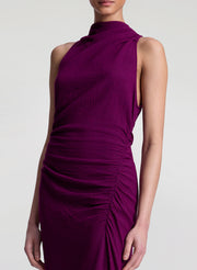 Woman wearing a purple dress on a white background