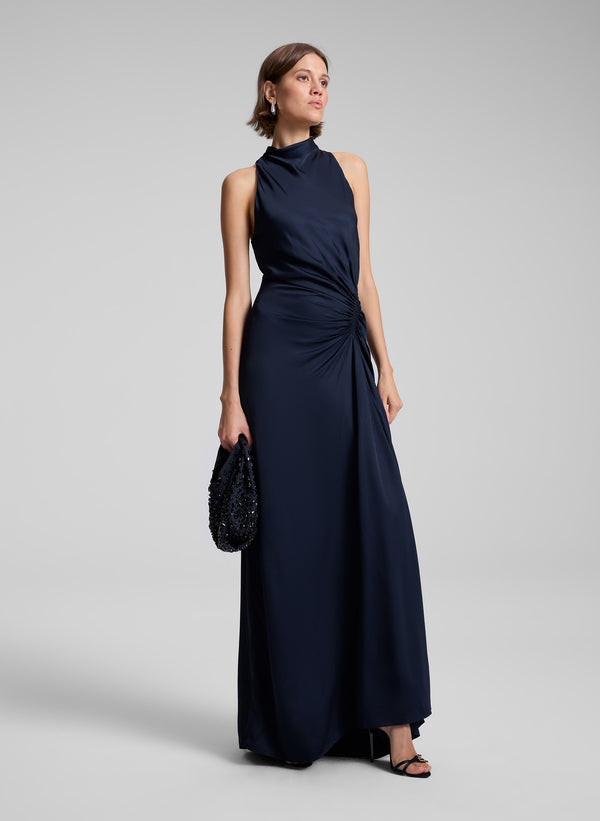 woman wearing navy blue gown with navy blue handbag with black rhinestones