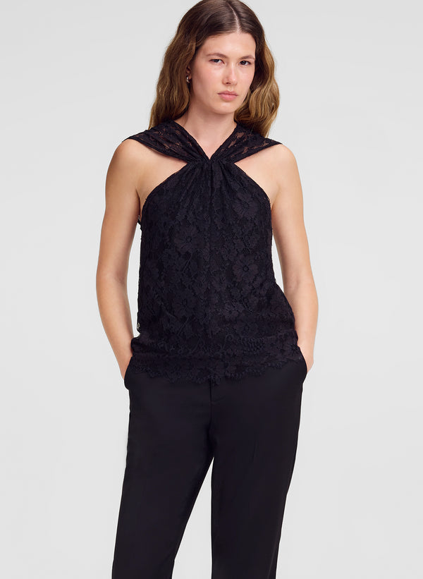woman wearing lace top and black pants