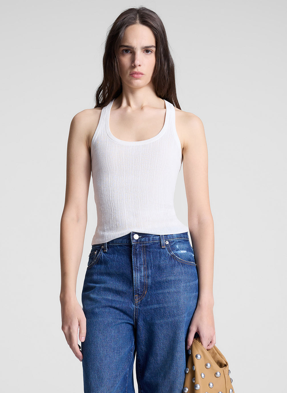 woman wearing white tank top and jeans