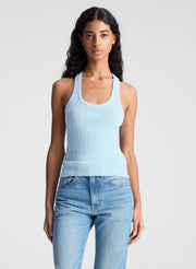 woman wearing ight blue tank top and light blue denim jeans