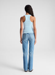 woman wearing ight blue tank top and light blue denim jeans