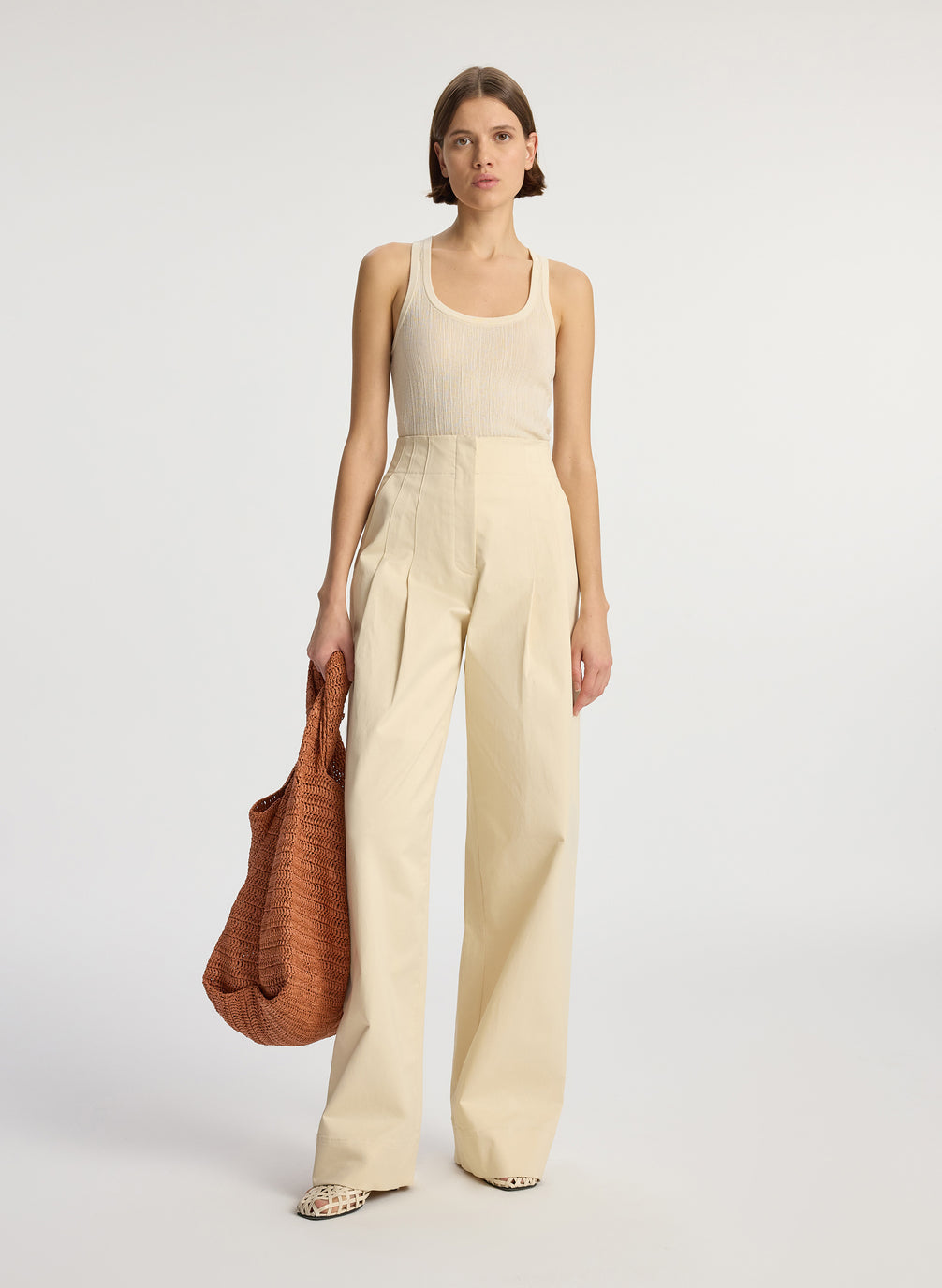 front view of woman wearing cream tank top and beige sateen wide leg pants
