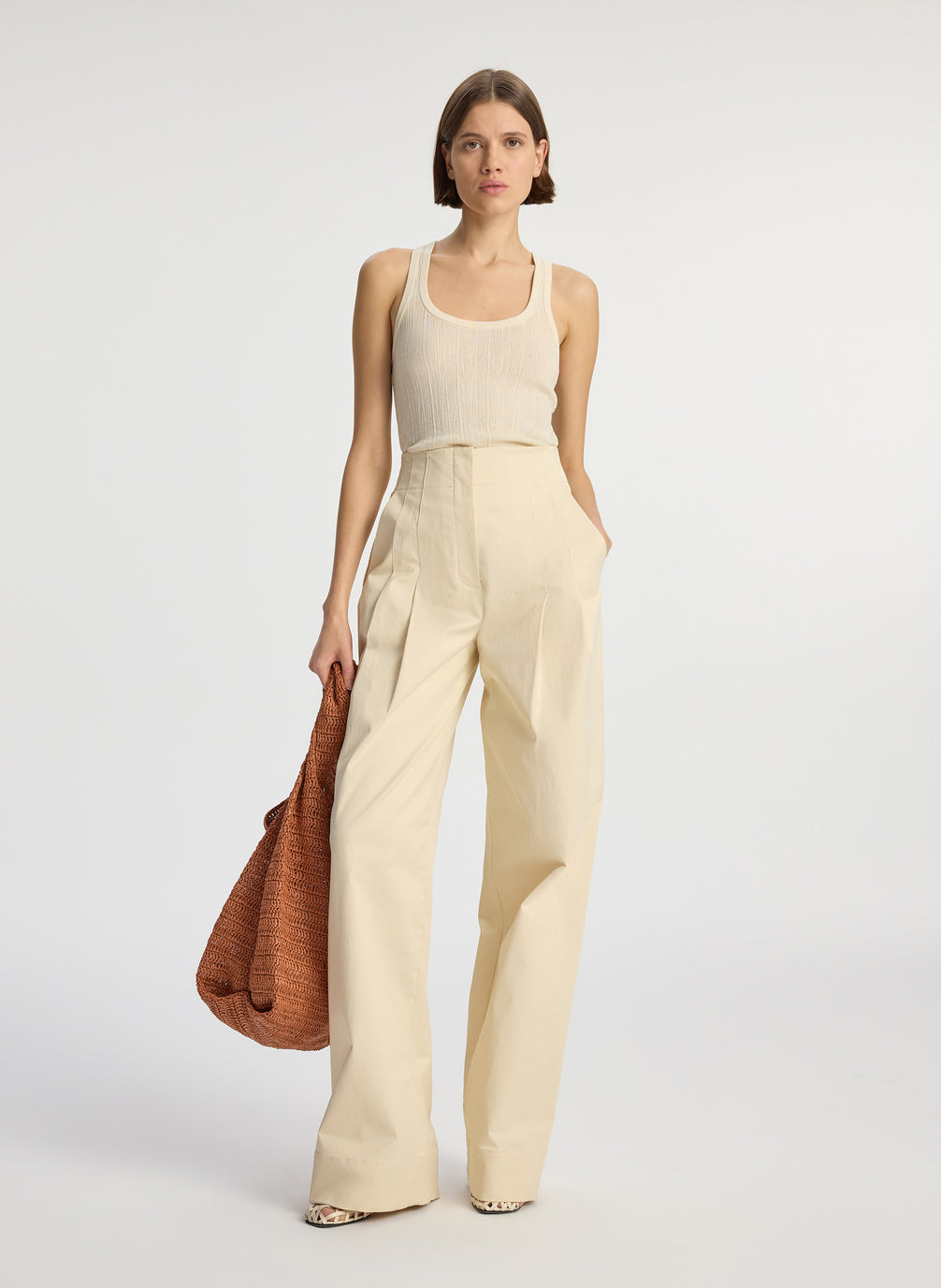 front  view of woman wearing cream tank top and beige sateen wide leg pants