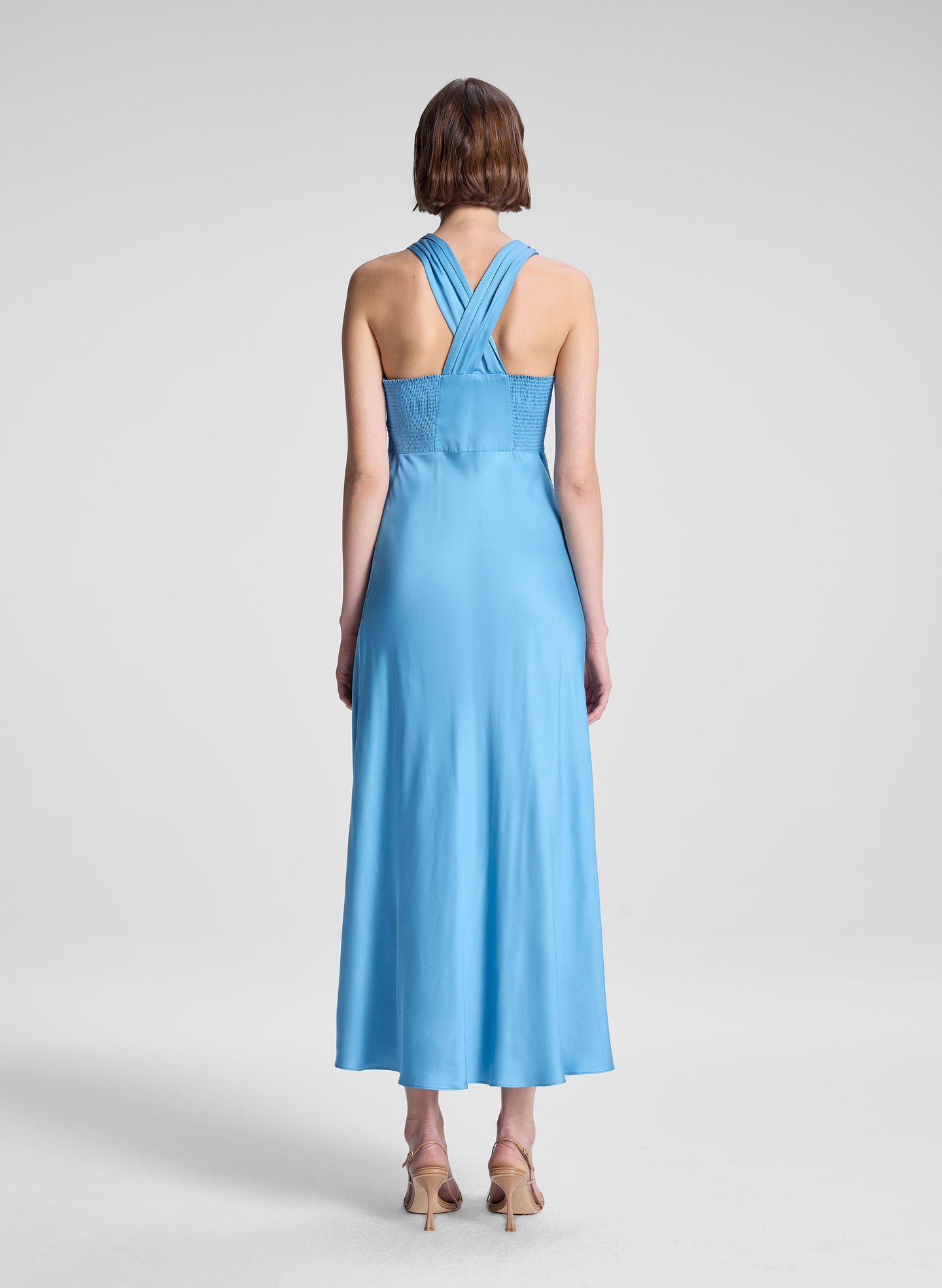 woman wearing blue satin midi dress