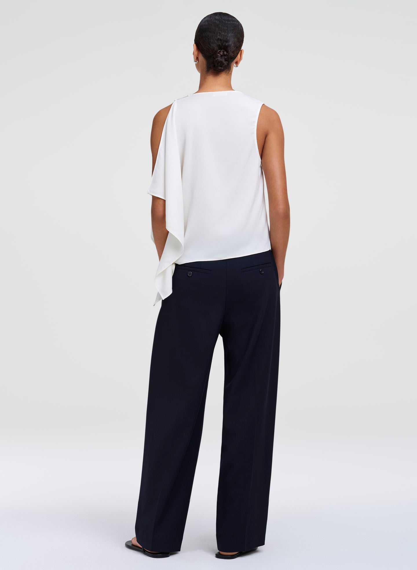 woman wearing white top and blue pants