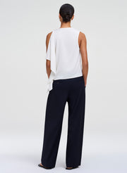 woman wearing white top and blue pants