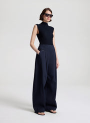 woman wearing navy blue sleeveless knit top and navy blue pants