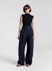 woman wearing navy blue sleeveless knit top and navy blue pants