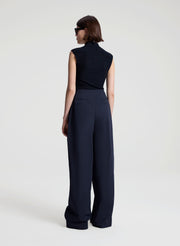 woman wearing navy blue sleeveless knit top and navy blue pants