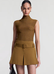 woman wearing brown sleeveless mock neck knit top and brown skort