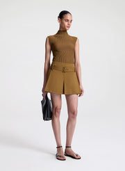 woman wearing brown sleeveless mock neck knit top and brown skort