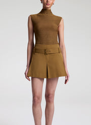 woman wearing brown sleeveless mock neck knit top and brown skort