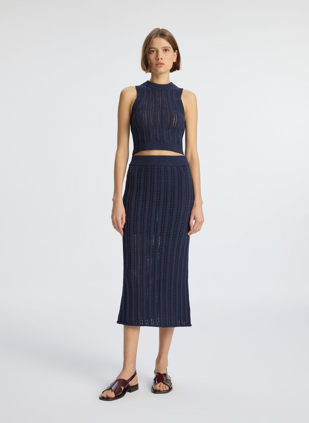 front  view of woman wearing navy blue woven tank top and matching midi skirt