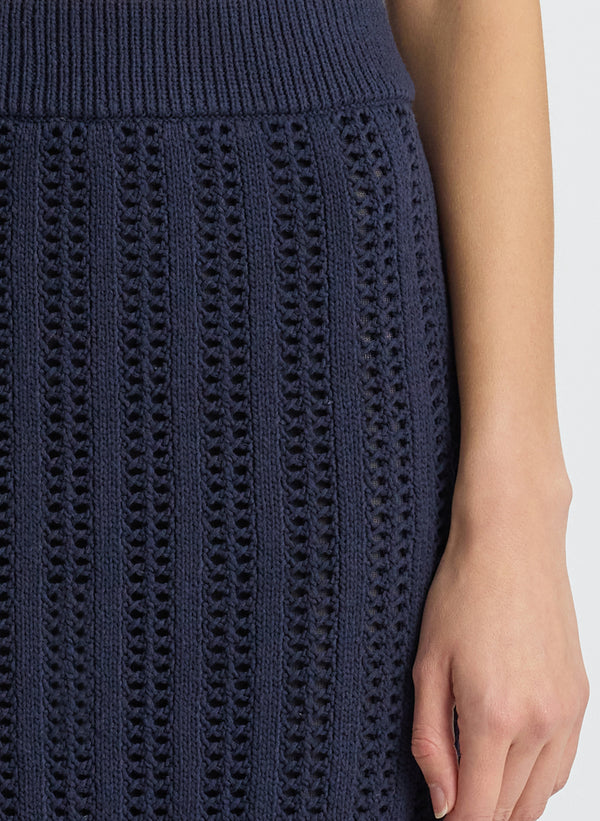 detail  view of woman wearing navy blue woven tank top and matching midi skirt