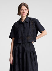 woman wearing black embroidered top and matching skirt set