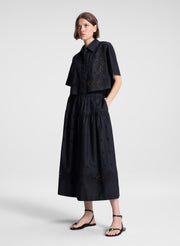 woman wearing black embroidered top and matching skirt set