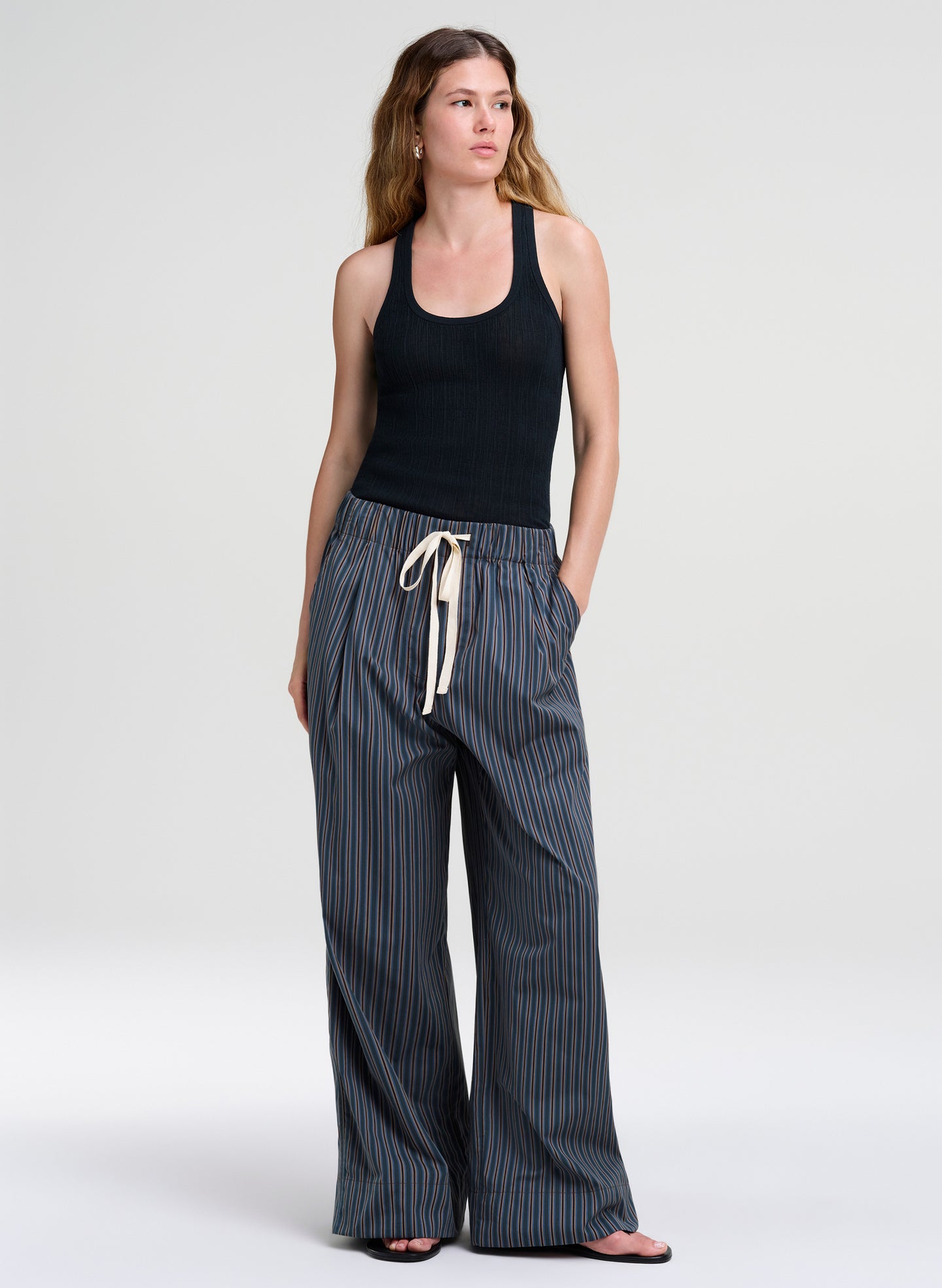 woman wearing green tank top and striped pants