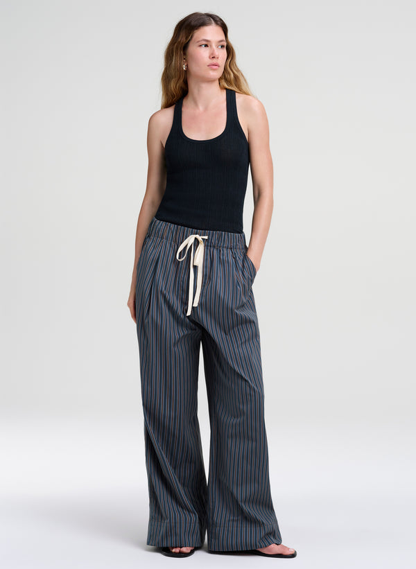 woman wearing green tank top and striped pants