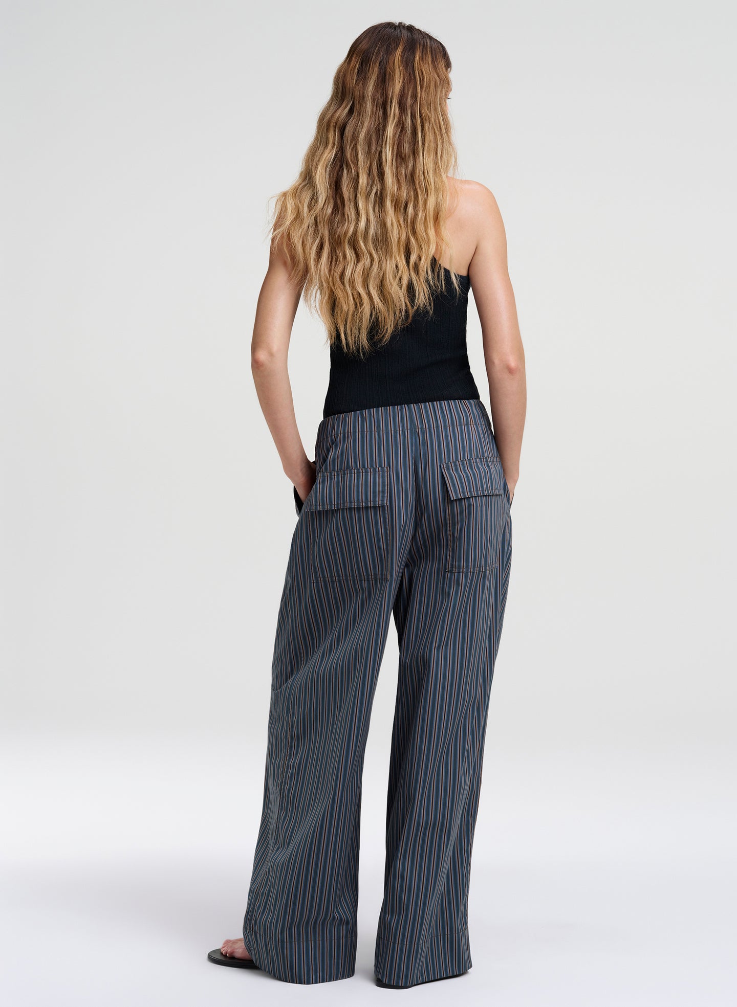 woman in striped pants and green tank top