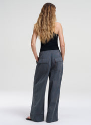 woman in striped pants and green tank top