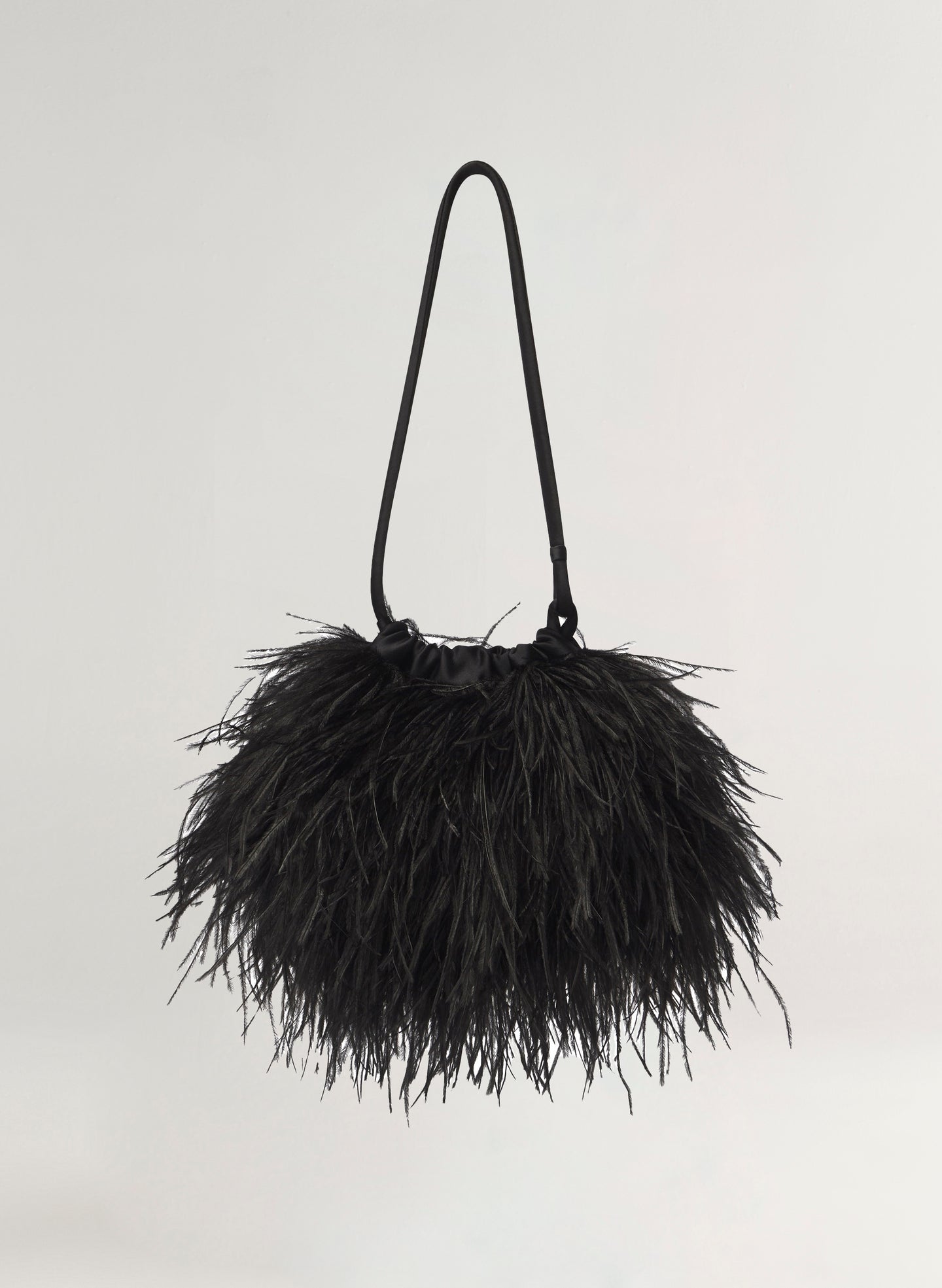 Black feathered handbag on a light gray background