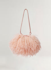 Pink feathered handbag on a light gray background