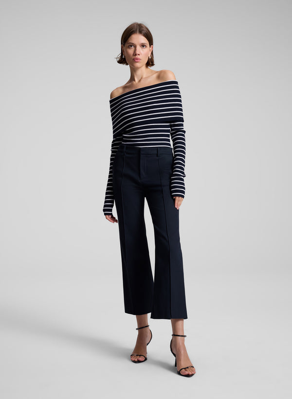 woman wearing navy blue striped off shoulder top and navy blue pants