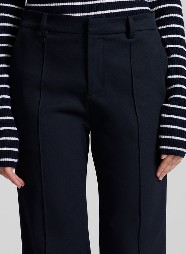 woman wearing navy blue striped off shoulder top and navy blue pants