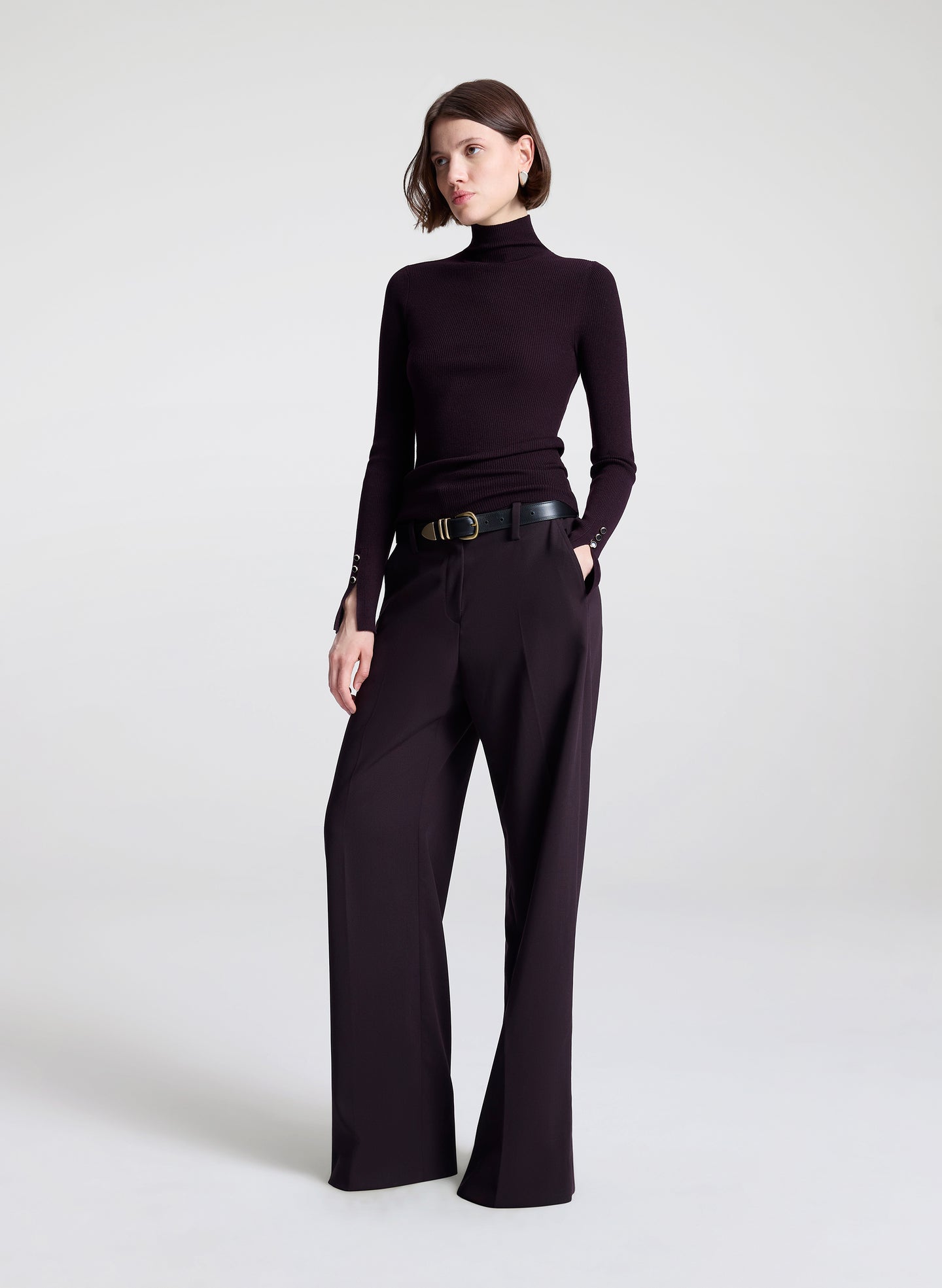 woman wearing purple turtleneck and purple pants