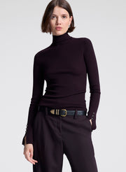 woman wearing purple turtleneck and purple pants