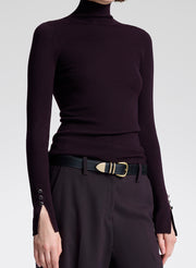 woman wearing purple turtleneck and purple pants